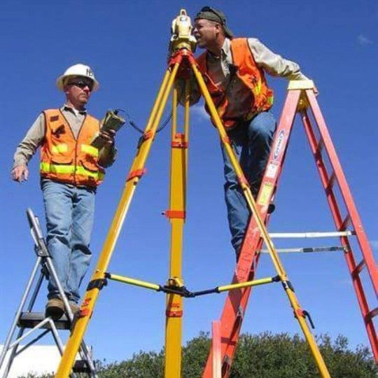 an image of 2 men both on ladders one is looking through a theodolite and the other man is holding a Land Survey device