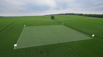 land-survey-boundaries-field Land surveying in a field. Division of land for future sale and development