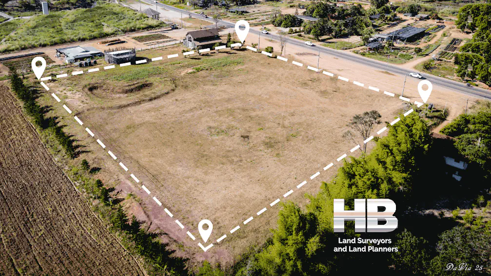 an image of a lot outline by white dashes to indicatre the boundary survey results, it looks like a warm sunny summer day