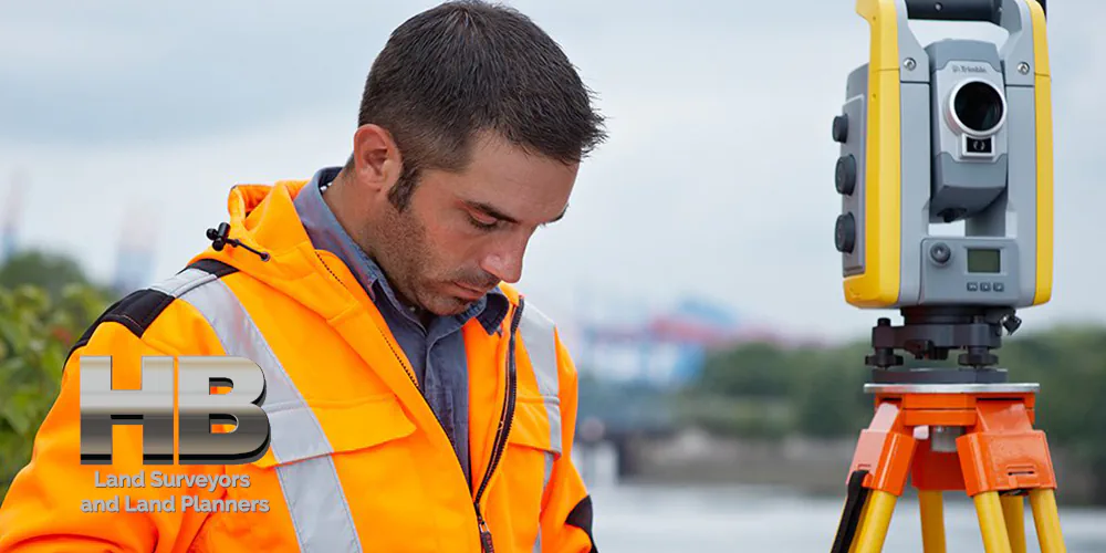 Land Survey Firms image of a Man conducting a land survey or a house location survey on a beautiful fall day in Frederick MD