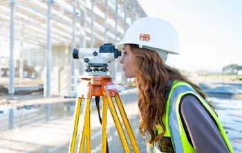 Property Line Surveyor in 2026 A mature woman conducting a property land survey v1.3 1590x A mature woman-conducting a property-land survey